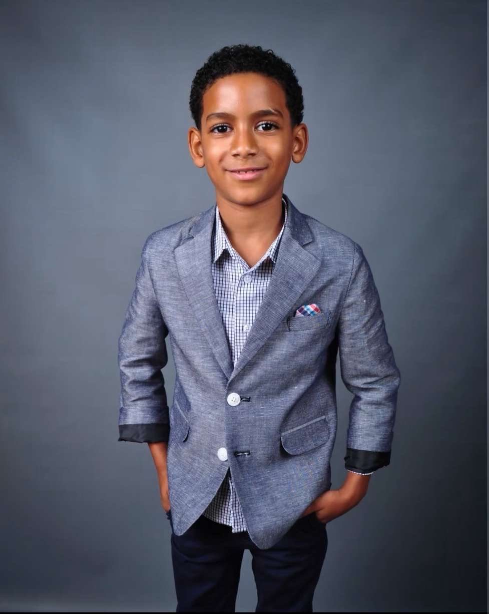 Azriel as a young boy in a blazer